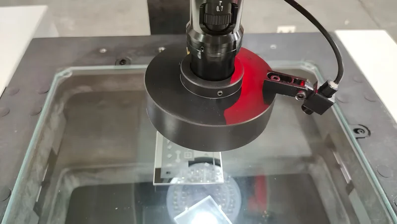 Operator measuring a molded part with calipers during dimensional inspection