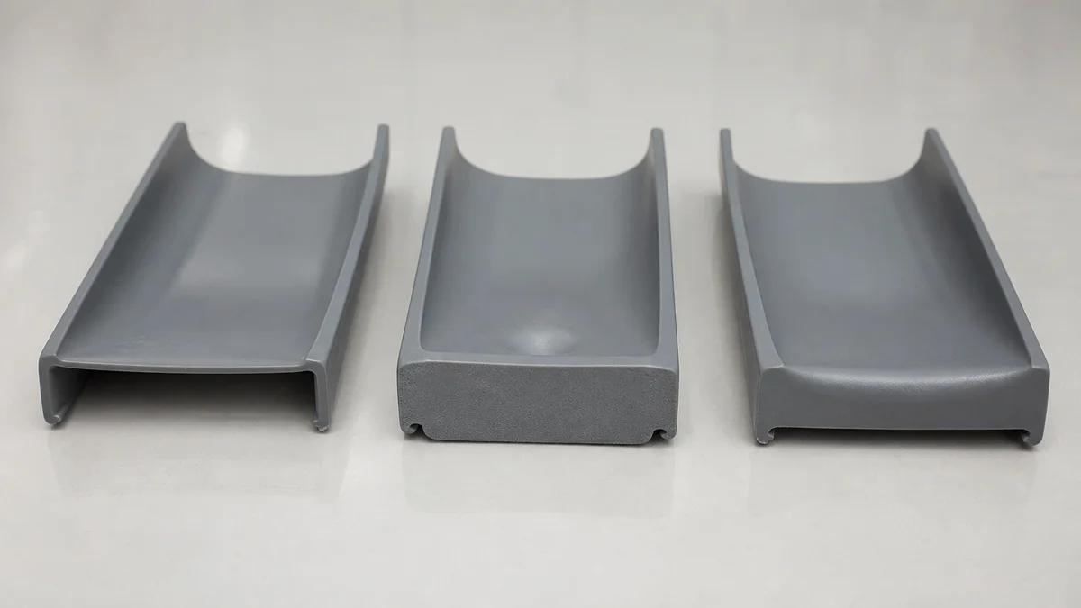 Molded plastic samples comparing uniform walls, a heavy section, and a gradual wall transition.